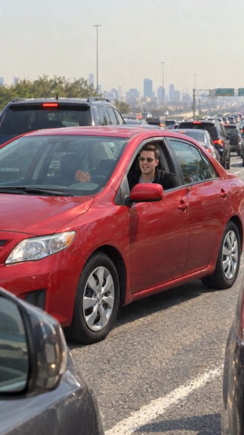 Car flying AI video: a red car about to boost over a traffic jam