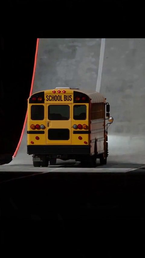 Car ramp jump AI video: a school bus climbs the curved ramp wall